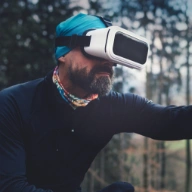 boy wearing virtual reality glasses in the forest