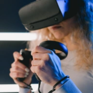 girl wearing virtual reality glasses to play video games